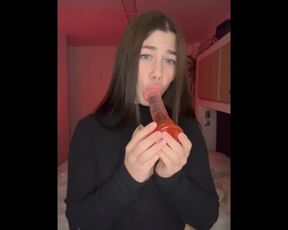 A girl sucks a dildo